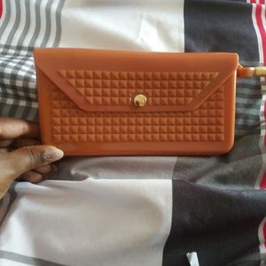 A tan brown wristlet